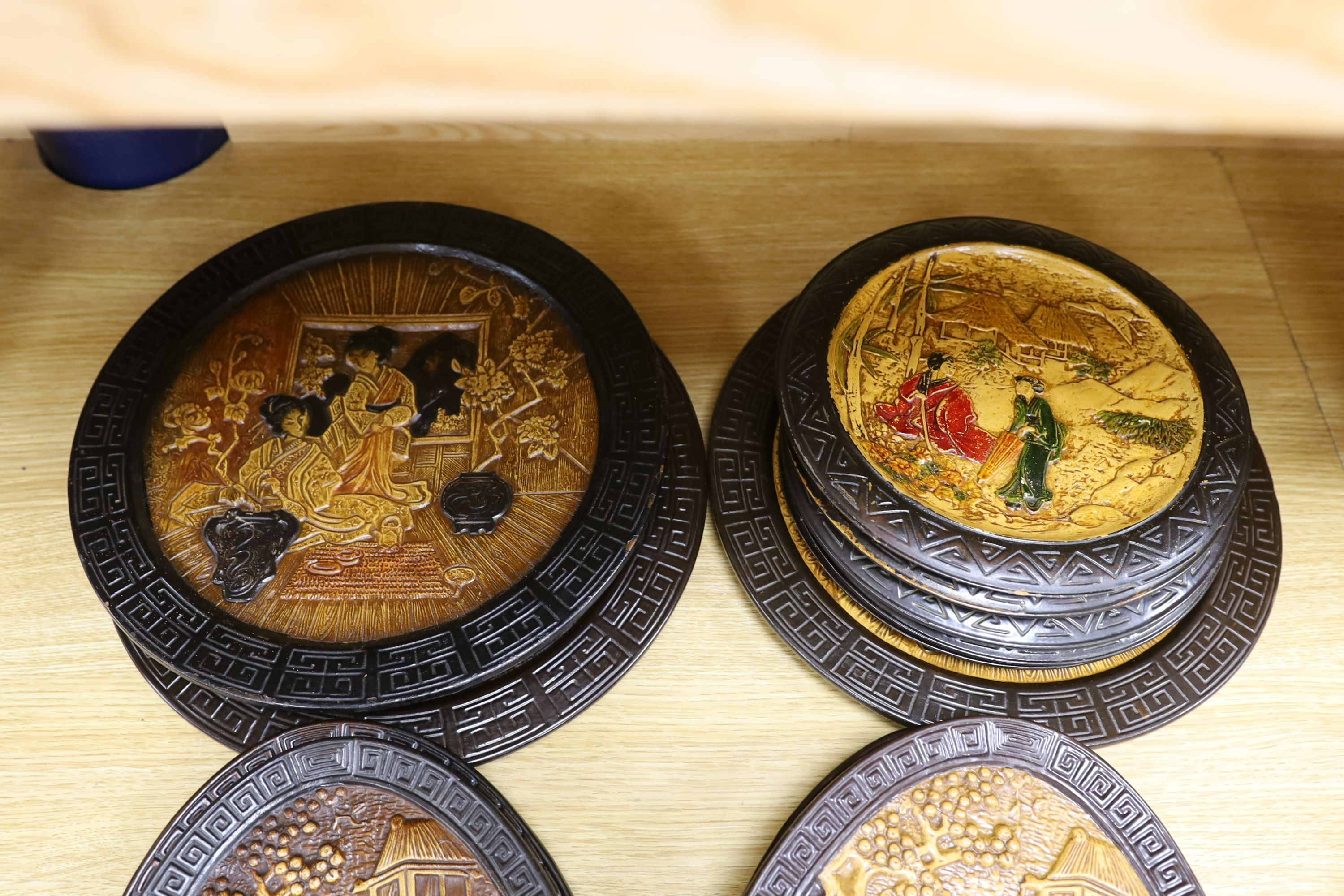 A collection of 13 Bretby chinoiserie wall plaques, largest 35cm diameter